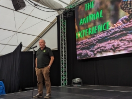 Mitch speaking to an audience in front of a screen